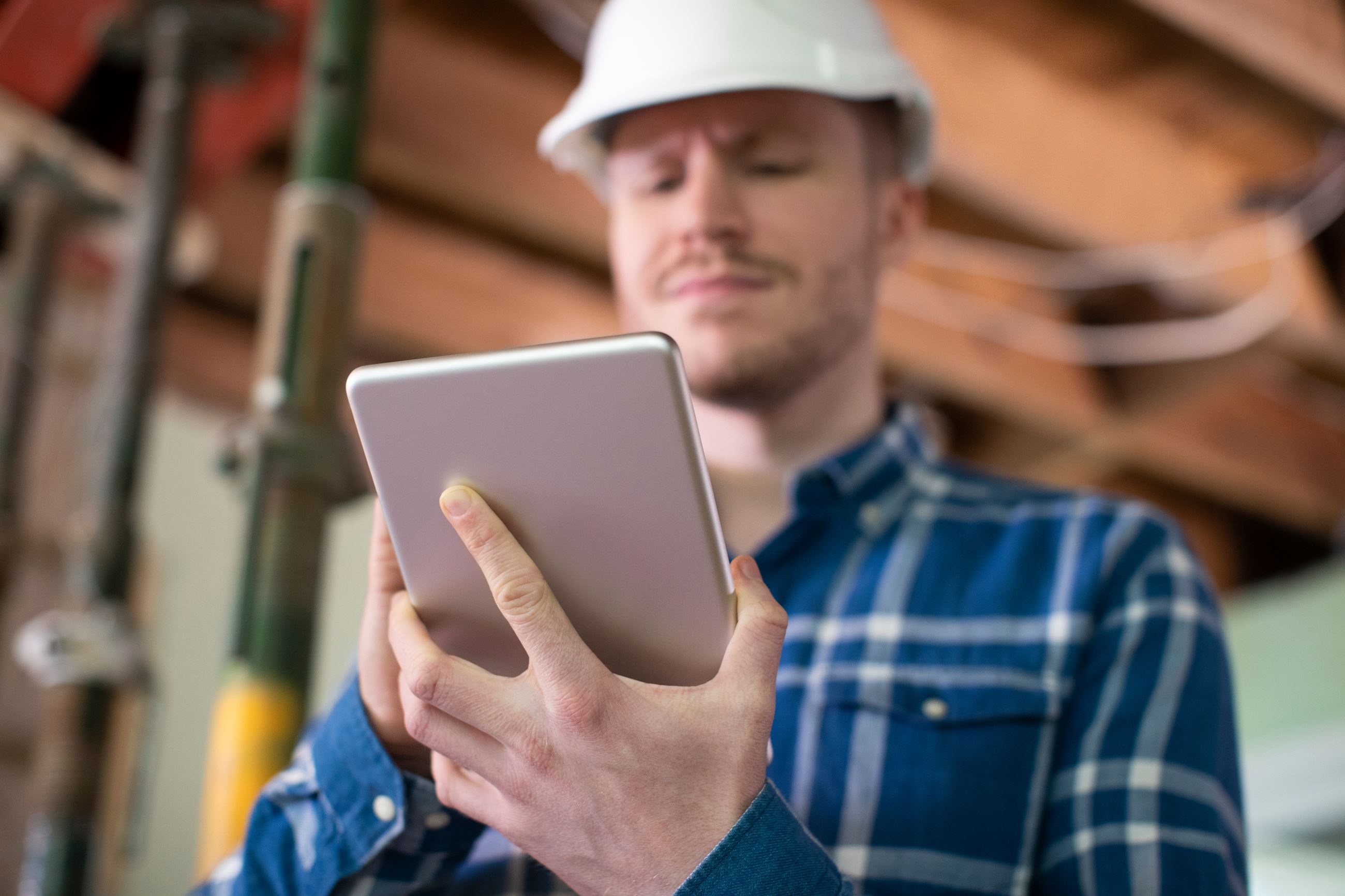 Contractor using tablet to perform a roof inspection