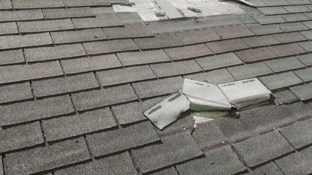 peeled up shingles from wind damage