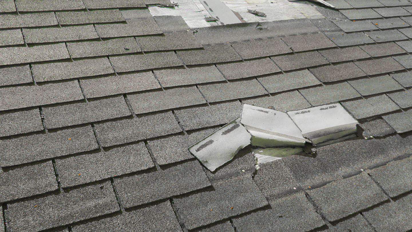 peeled up shingles from wind damage