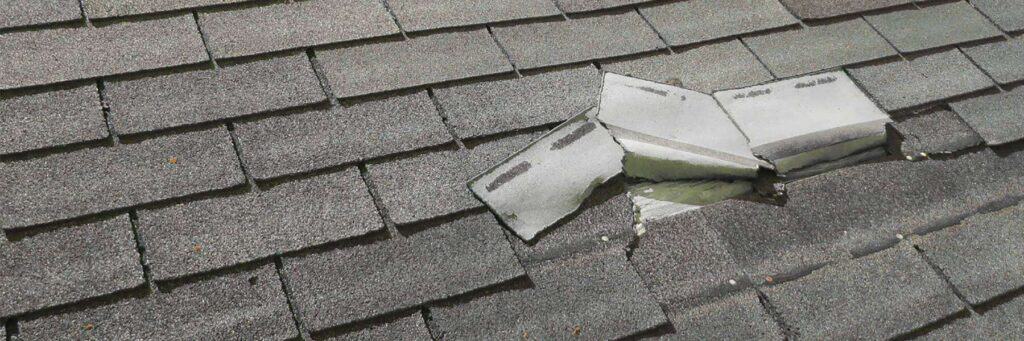 peeled up shingles on a roof