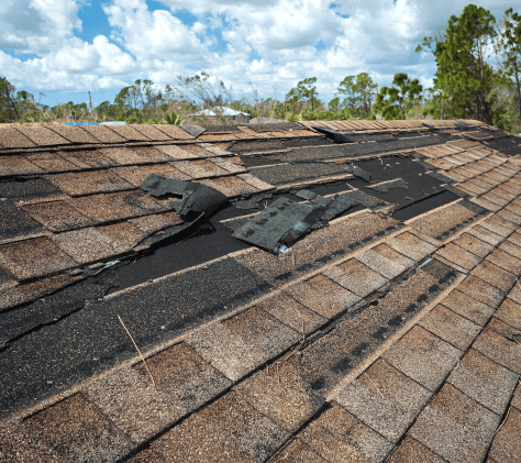 Hurricane Damage to a tan shingle roof