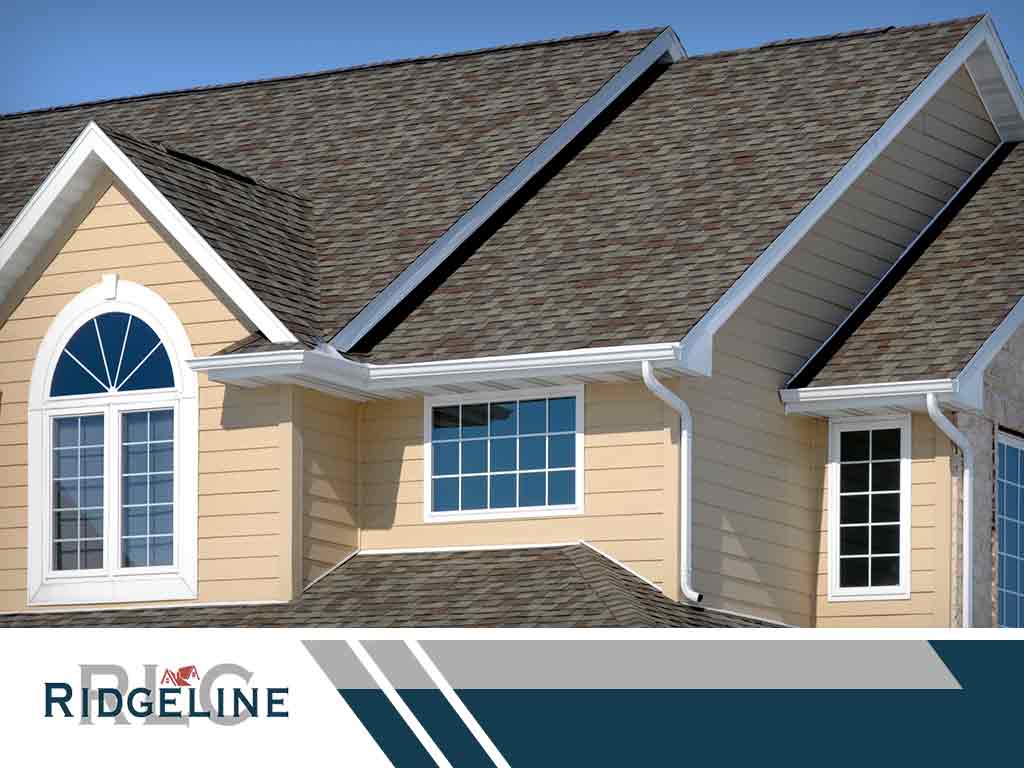 house with shingle roof gutters and siding