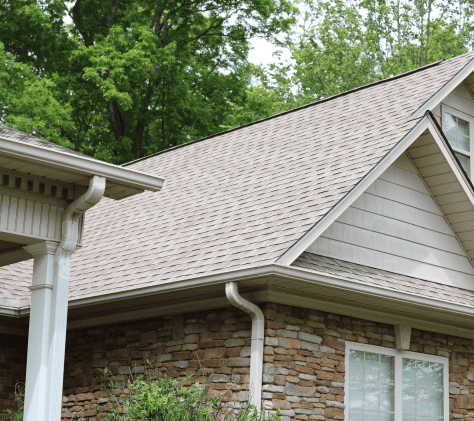 new-asphalt-shingle-roof-on-stone-brick-house