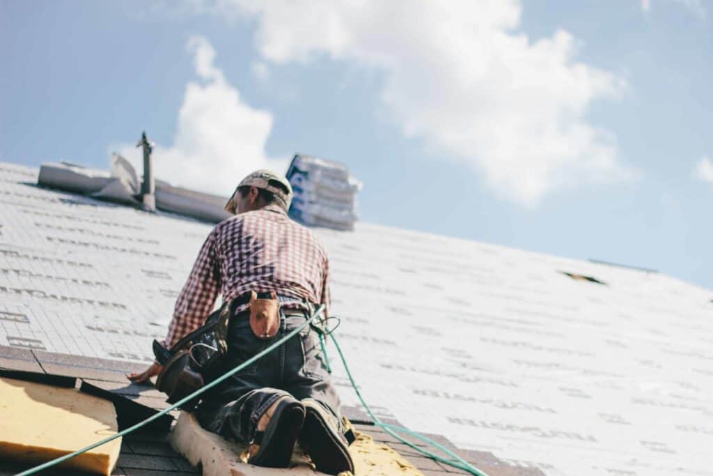 construction worker wearing safety gear on a roof