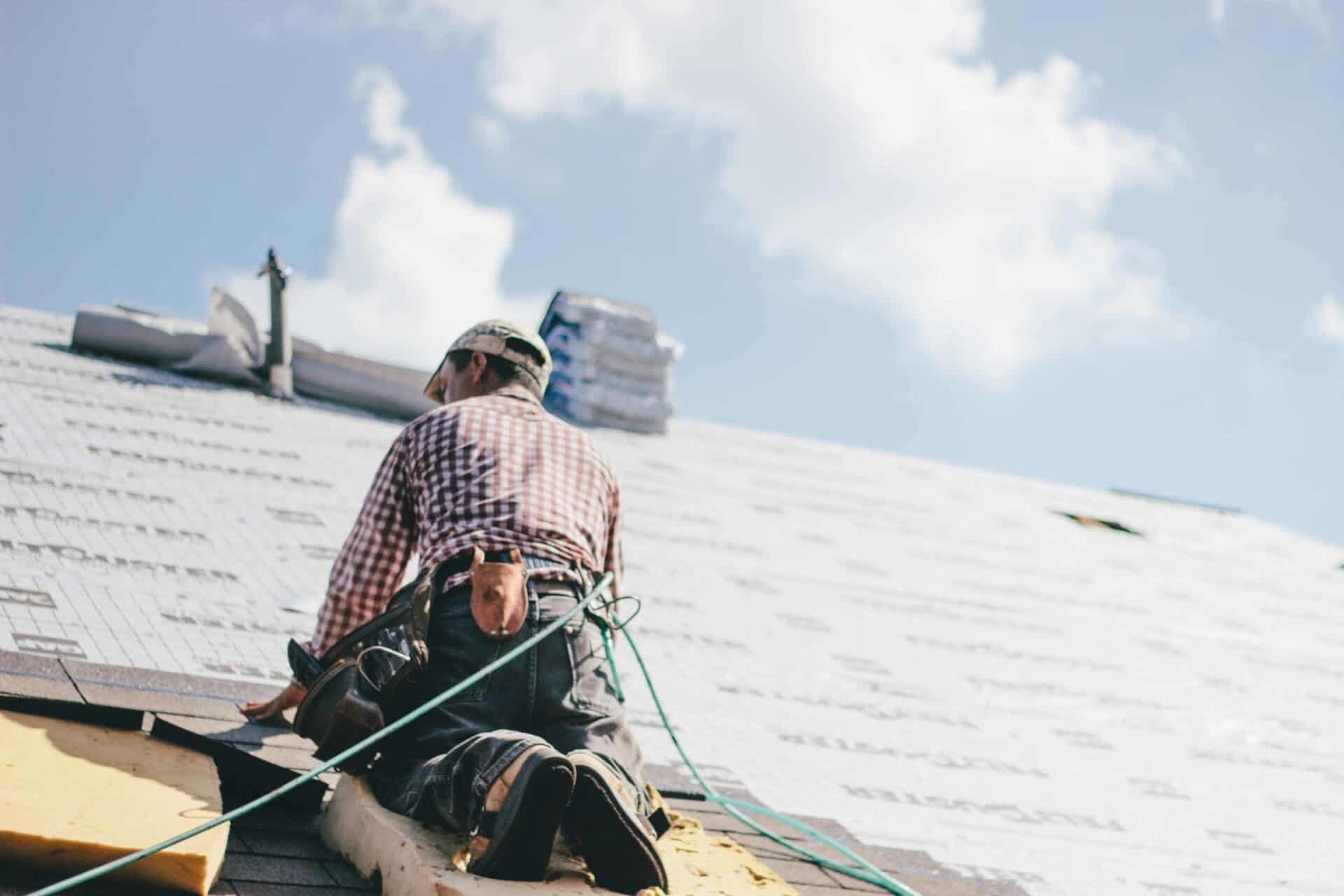 construction worker wearing safety gear on a roof