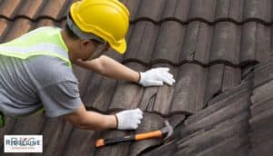 worker inspecting a damaged clay tile